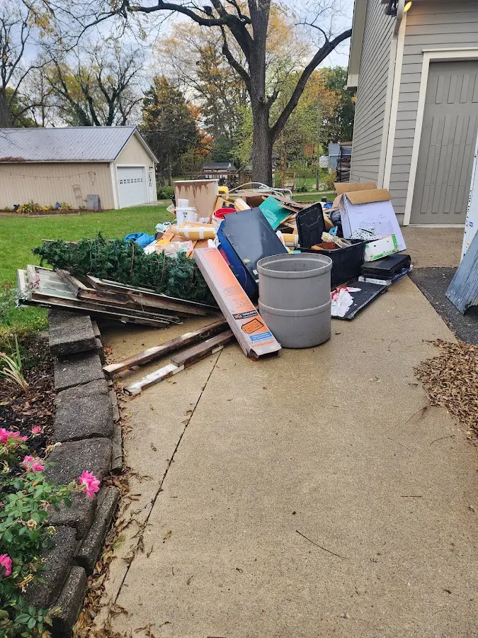 Dumpster being loaded with debris for Estate Cleanout Dumpster Rental in Bourbonnais